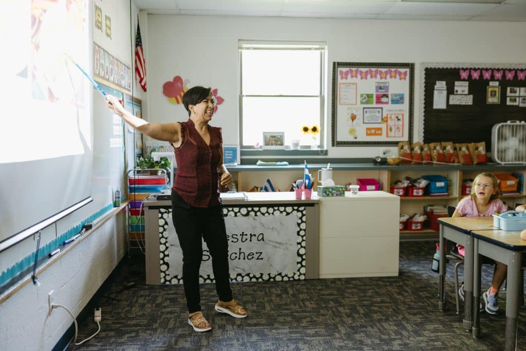 Spanish Immersion Teacher pointing to the board