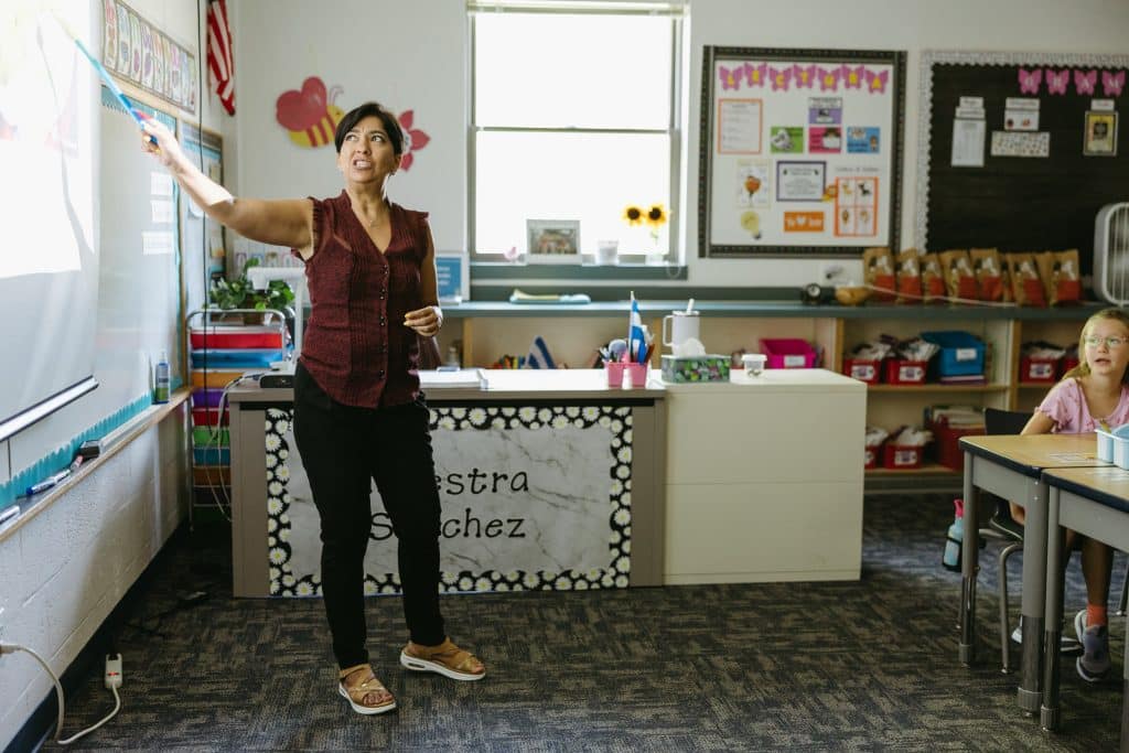 Spanish Immersion Teacher pointing to the board