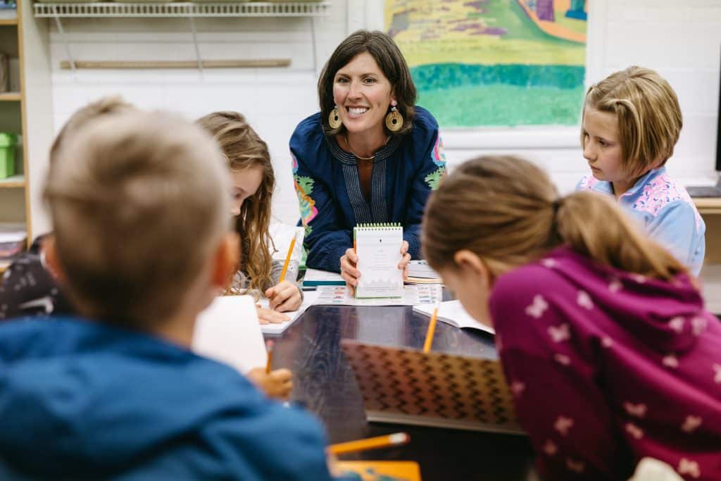 Students in class, writing on notepads