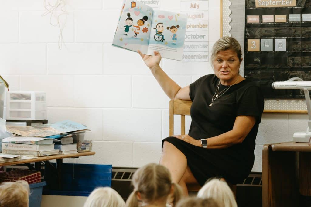 Teacher reading to her class from a picture book